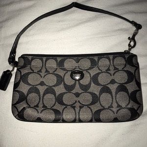 A black coach wrist bag